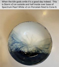 a white and blue bowl sitting on top of a counter next to a black object