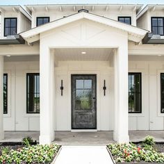 a white house with black doors and windows