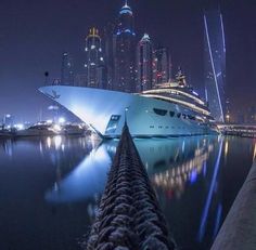 a cruise ship docked in the harbor at night