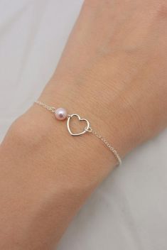 REAL STERLING SILVER - A QUALITY GIFTI make this beautiful bracelet using a delicate sterling silver heart charm set on sterling silver chain (all 925 sterling). A 6mm Swarovski pearl completes the look and is available in your choice of five colors. Secures with a lobster clasp and comes in a gift box, perfect for gift-giving. These make great group gifts.SIZING - IMPORTANT: To determine bracelet size, measure around your wrist and add 1/2 inch to get your bracelet size. Do not order in your ex Tiny Heart Bracelet, Minimalist Jewelry Silver, Sterling Silver Heart Bracelet, Dot Necklace, Silver Heart Bracelet, Sterling Silver Cross Necklace, Group Gifts, Tiny Heart, Dainty Bracelets