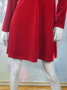 This red velvet dress has a round neckline, with a shimmering band of faux red coral gemstone bars and diamanté crystals in the front. The European vintage slip-on dress has long sleeves, a fitted waistline, and a semi-flared skirt. Bust = 42 inches (106.68cm) Shoulders = 17 inches (43.18cm) Waist = 36 inches (91.44cm) Hips = 45 inches (114.3cm) Dress Length = 37 inches (93.98cm) Size: 14 US, 18 UK Material: 90% polyester, 10% elastan --- CONDITION --- This stunning red velvet dress is vintage, Long Sleeve Velvet Dress For Holidays, Velvet Long Sleeve Party Dress, Knee-length Velvet Dress For Winter, Red Velvet Long Sleeve Dress For Fall, Red Velvet Dress For Winter, Red Velvet Dress For Holidays, Holiday Red Velvet Dress, Red Fitted Velvet Dress For Winter, Fitted Red Velvet Winter Dress