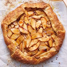 an apple pie is shown on a piece of parchment paper