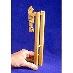 a hand holding a wooden door handle on a blue background