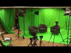 a green screen studio with chairs and lights