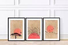 three framed art pieces on a wall in front of a wooden floor and white walls