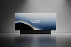 a television screen with the words beyond forms on it in front of two spotlights