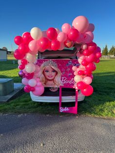 an ice cream truck decorated with balloons and a barbie photo on the back door for a birthday party