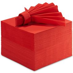 a stack of red napkins with a bow on the top and one folded up