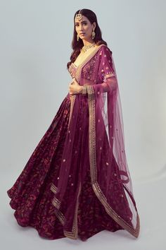 Magenta gathered lehenga with floral embroidered motifs. Comes with blouse and dupatta.
Component: 3
Pattern: Embroidery
Type Of Work: Dori and Sequin Work
Neckline: Sweetheart
Sleeve Type: Half
Fabric: Dupion Silk and Net
Color: Purple
Other Details: 
Blouse with sequin and thread work
Dupatta with embroidered border
Low back with tie up and tassels
Closure: Hook back
Occasion: Wedding - Aza Fashions Gathered Lehenga, Net Embroidery, Embroidered Motifs, Embroidered Lehenga, Embroidered Border, Dupion Silk, Pattern Embroidery, Thread Work, Embroidered Silk