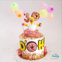 a birthday cake decorated with donuts and sprinkles for a doh