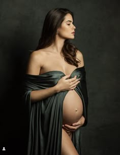 a pregnant woman is wrapped in a blanket