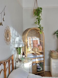 a bedroom with wicker furniture and plants on the wall