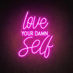 a neon sign with the words love your damn self in pink on a dark background