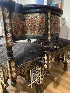 an ornate wooden bench with intricate carvings on the back and sides, sitting on a hard wood floor