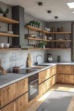 a kitchen filled with lots of wooden cabinets and counter top space next to a window