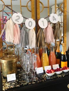 a table topped with lots of bottles of wine and glasses filled with liquid next to each other