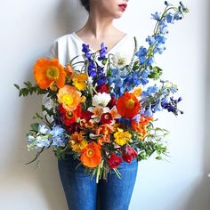 a woman holding a bouquet of flowers in her hands