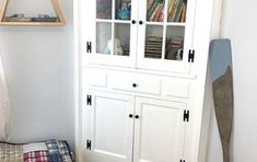 a white bookcase sitting next to a bed in a room