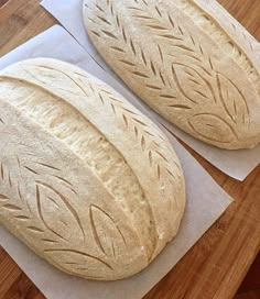 two loaves of bread sitting on top of paper