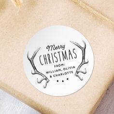 a christmas gift wrapped in brown paper with reindeer antlers on the side and merry christmas from william olvia & charlotte