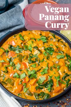 vegan panang curry in a skillet with cilantro and parsley