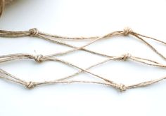 some twine is tied together on a white surface