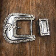 "A set of 3 silver tone metal southwestern/cowboy style belt buckle parts. I'll do my best to describe these but I have to admit that I know nothing about using these to ornament a belt. I just fell in love with the color and details on these pieces. I also am not able to identify the metal. All three definitely look vintage, have wear, and have tarnished over time. Please refer to the photo numbers for the measurements given below: Photo #3 Belt Buckle - There's a small circle with the head of Vintage Silver Belts For Rodeo, Vintage Silver Belt Buckles For Western-themed Events, Adjustable Antique Silver Belt Buckles, Silver Adjustable Belt For Rodeo, Vintage Silver Belt Buckles For Rodeo, Vintage Silver Belt Buckle For Rodeo, Adjustable Silver Southwestern Belt Buckles, Western Silver Belt With Antique Buckle, Western Silver Belt Buckles With Concho