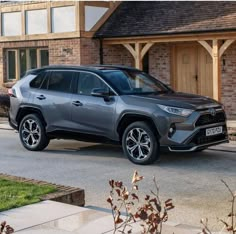 a grey toyota rav parked in front of a house