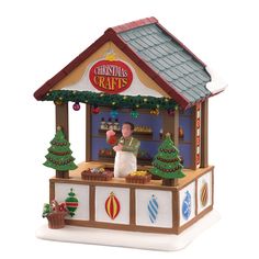 a small toy store with christmas decorations on the front and side of it's roof