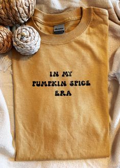 Welcome the cozy autumn vibes with this "In My Pumpkin Spice Era" T-shirt! Perfect for pumpkin spice lovers, this shirt captures the essence of fall with its cute and trendy design. Made from high-quality, soft cotton, it's the ideal companion for chilly days, coffee runs, and all your seasonal activities. Material: Gildan heavy cotton, ensuring durability and comfort. Color: Autumn-inspired mustard shade that pairs perfectly with fall outfits. Design: Unique retro-style typography for the phras Seasonal Activities, Autumn Inspired, Aesthetic Shirt, Fall Tee, Aesthetic Shirts, Cozy Autumn, Autumn Vibes, Fall Aesthetic, Autumn Cozy