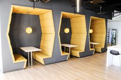 the interior of a restaurant with yellow booths