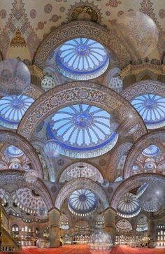 an ornately decorated ceiling in a building with many circular windows and intricate designs on the ceiling