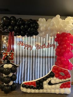 a birthday display with balloons and nike shoes