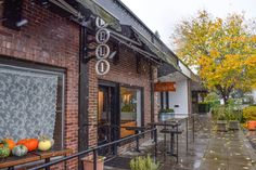 an outside view of a restaurant with pumpkins and gourds on the windows