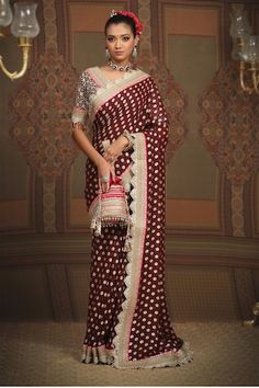 Maroon floral pattern saree, embellished with intricate gota, dori and badla work and rani pink border. Comes with silk chanderi padded blouse with scalloped neckline. - Aza Fashions Traditional Pre-draped Saree With Mirror Work For Reception, Reception Art Silk Blouse Piece With Motifs, Georgette Dupatta With Motifs For Reception, Reception Georgette Dupatta With Motifs, Reception Saree Blouse With Motifs, Georgette Pre-draped Saree With Motifs For Wedding, Navratri Reception Saree With Motifs, Wedding Pre-draped Saree With Motifs In Georgette, Wedding Pre-draped Georgette Saree With Motifs