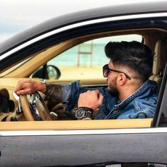 a man sitting in the driver's seat of a car