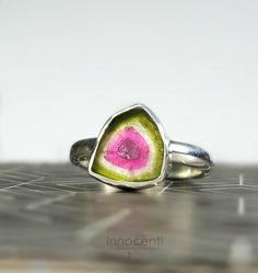 Unique watermelon tourmaline engagement ring featuring gorgeous rare watermelon tourmaline slice. Elegant, delicate and versatile. Materials: ✔Sterling silver band ✔High quality polished tourmaline slice. ✔Gemstone size ~ 8-16mm. Please note that the ring of the picture is sold out and it is used as a sample. You have to choose from the last picture and the video the gemstone you like before checkout and I will make a ring in your size with the gemstone you picked. You will get it in a beautiful Watermelon Tourmaline Engagement Ring, Slice Watermelon, Slice Ring, Watermelon Tourmaline Ring, Tourmaline Engagement Ring, Watermelon Slice, Tourmaline Jewelry, Tourmaline Ring, Watermelon Tourmaline