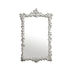 a white frame with flowers on it and a mirror in the back ground that is shaped like a flower