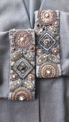 two pieces of beaded cloth are attached to the lapel of a suit