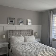 a bed with white sheets and pillows in a bedroom next to two pictures on the wall