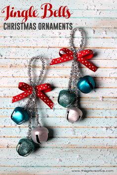 three bells with bows hanging from them on a wooden surface and snow flakes around them