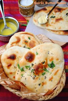 three pita breads sitting on top of a table next to some dipping sauce