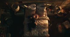 an overhead view of a bed in a room with many hats on the headboard