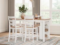 a dining room table with four chairs and a potted plant on the top shelf