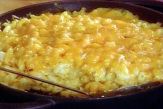 macaroni and cheese is being cooked in a skillet