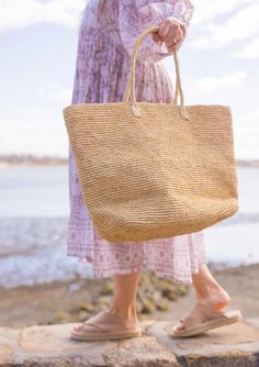 A timeless and chic tote that you can wear from spring to summer! Our Jane tote is a great accessory for running to the market and holding your goodies. Material: 100% Raffia Measurements: 13.5" x 22.8", Handle Drop- 8" Optional leather loop included to carry your fave hat Care: Spot Clean with Damp Cloth Spring Crochet Bag With Double Top Handles, Spring Tote Bag With Top Carry Handle, Spring Crochet Bag With Top Carry Handle, Spring Beige Bags With Rolled Handles, Natural Color Rectangular Crochet Bag With Rolled Handles, Summer Top Handle Bag With Rolled Handles, Chic Rectangular Beach Bag With Rolled Handles, Natural Rectangular Crochet Bag With Rolled Handles, Rectangular Natural Crochet Bag With Rolled Handles