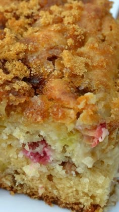 a close up of a piece of cake on a plate with crumb toppings