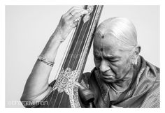 an old woman holding a harp in her hands