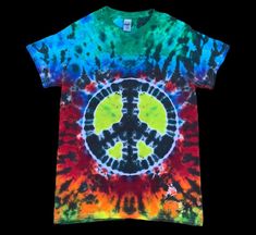 One of one raknbow peace sign design! Size small ! SIZING / MEASUREMENTS    please check the size charts provided for measurements on the crop and tank tops! Ive gotten feedback from some that they run a bit big!  CARE INSTRUCTIONS  Every shirt is dyed with professional grade fiber reactive procion dye that will last a life time!( more like many life times  Always wash your tie dye in cold water, to reduce any fading that may occur. Wash separately from whites , at least the first few washes to Hippie Tie Dye Tops For Festivals, Hippie Multicolor Short Sleeve T-shirt, Multicolor Short Sleeve Hippie T-shirt, Hippie Tie Dye T-shirt For Festivals, Hippie Hand Dyed Tie Dye T-shirt, Hand Dyed Hippie Short Sleeve T-shirt, Hippie Tie Dye Crew Neck T-shirt, Hippie Tie-dye Short Sleeve Tops, Hippie Tie Dye Short Sleeve Top