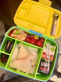 an open lunch box filled with food and utensils